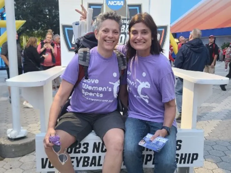 Julie Lane and a fellow supporter in Save Women’s Sports shirts at the 2023 NCAA volleyball championship