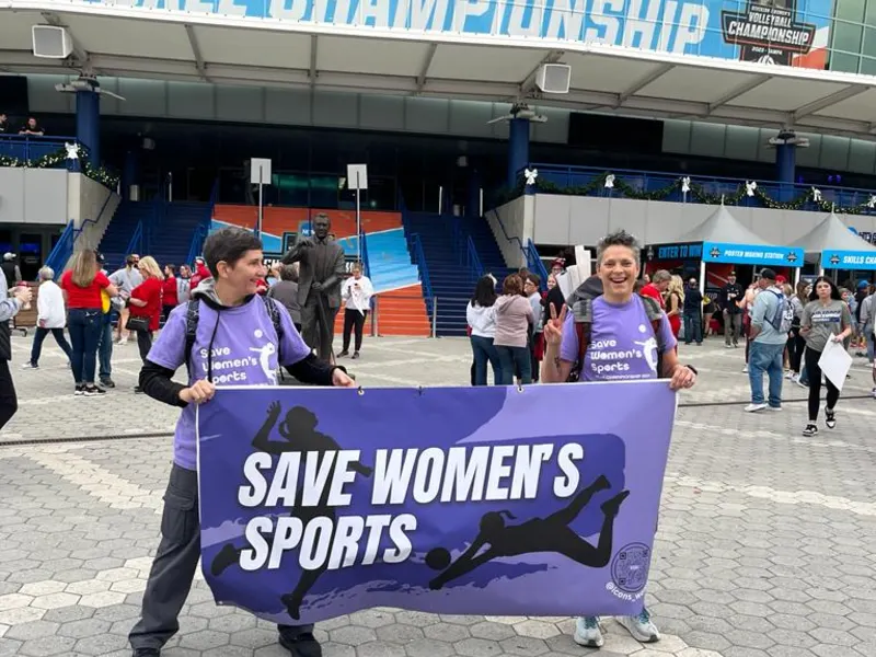 Supporters hold a Save Women’s Sports banner outside the 2023 NCAA volleyball championship in Tampa